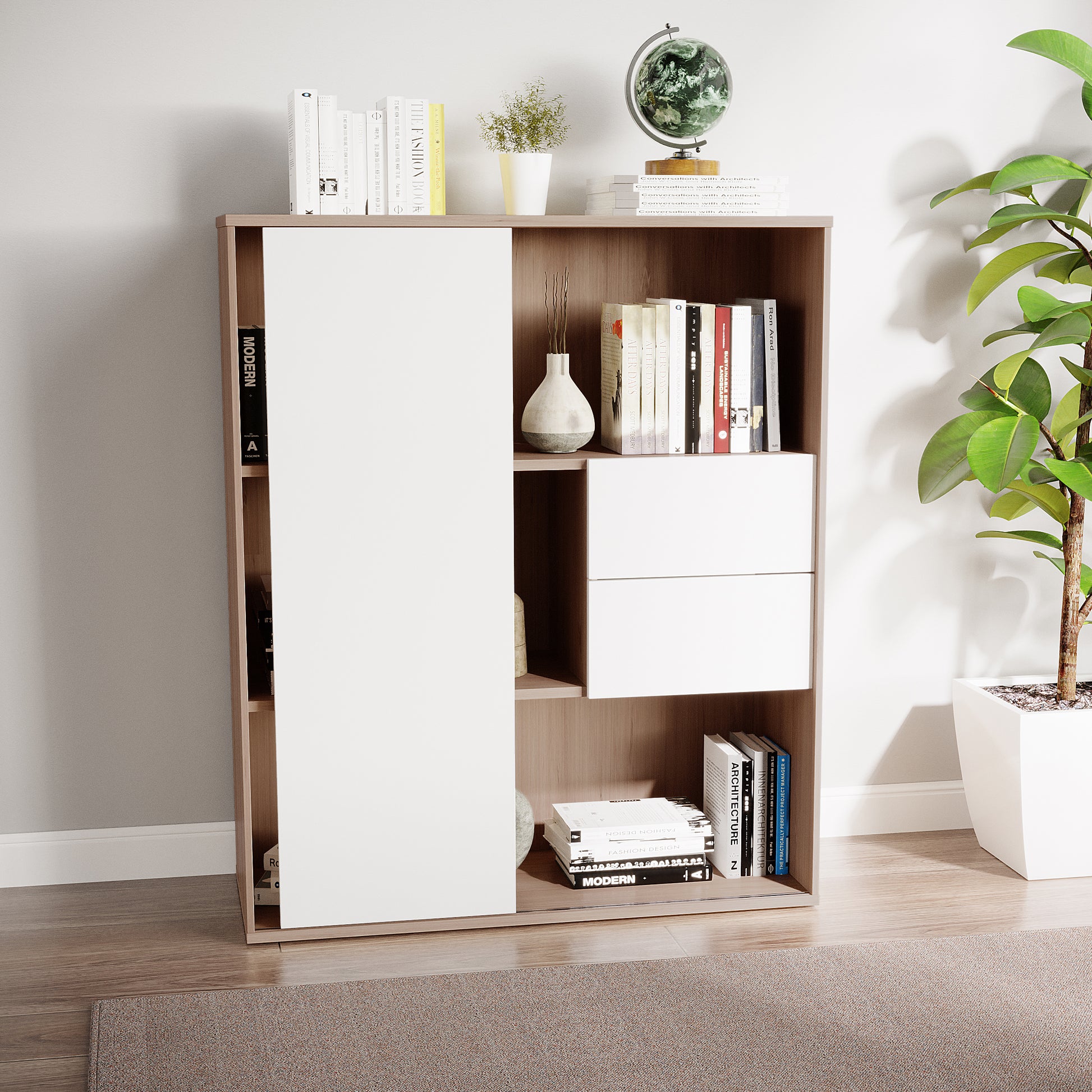 Eiresa Home Office Bookshelf with Door in Walnut White, featuring light wood panels, white sliding doors, drawers, and open shelves holding books, a globe, vase, and plant, complemented by a nearby tall houseplant.