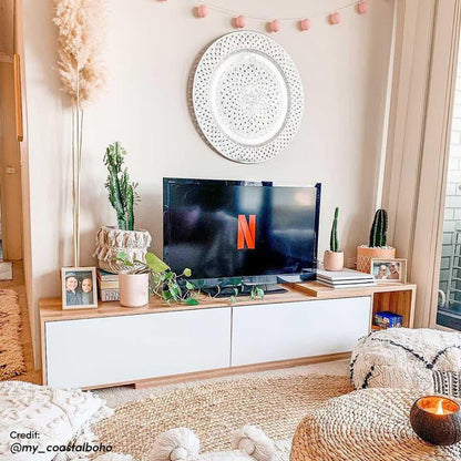 Eloise Entertainment Unit with Shelves - White, featuring open shelves and push-to-open doors, displayed in a living room setting with a TV and decorative items like a cactus and coconut shell candle.