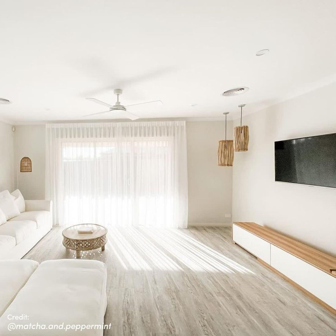 Eloise Entertainment Unit with Shelves - White, featuring adjustable length, open shelves, and push-to-open doors, designed for modern living room organization and showcasing decor items.