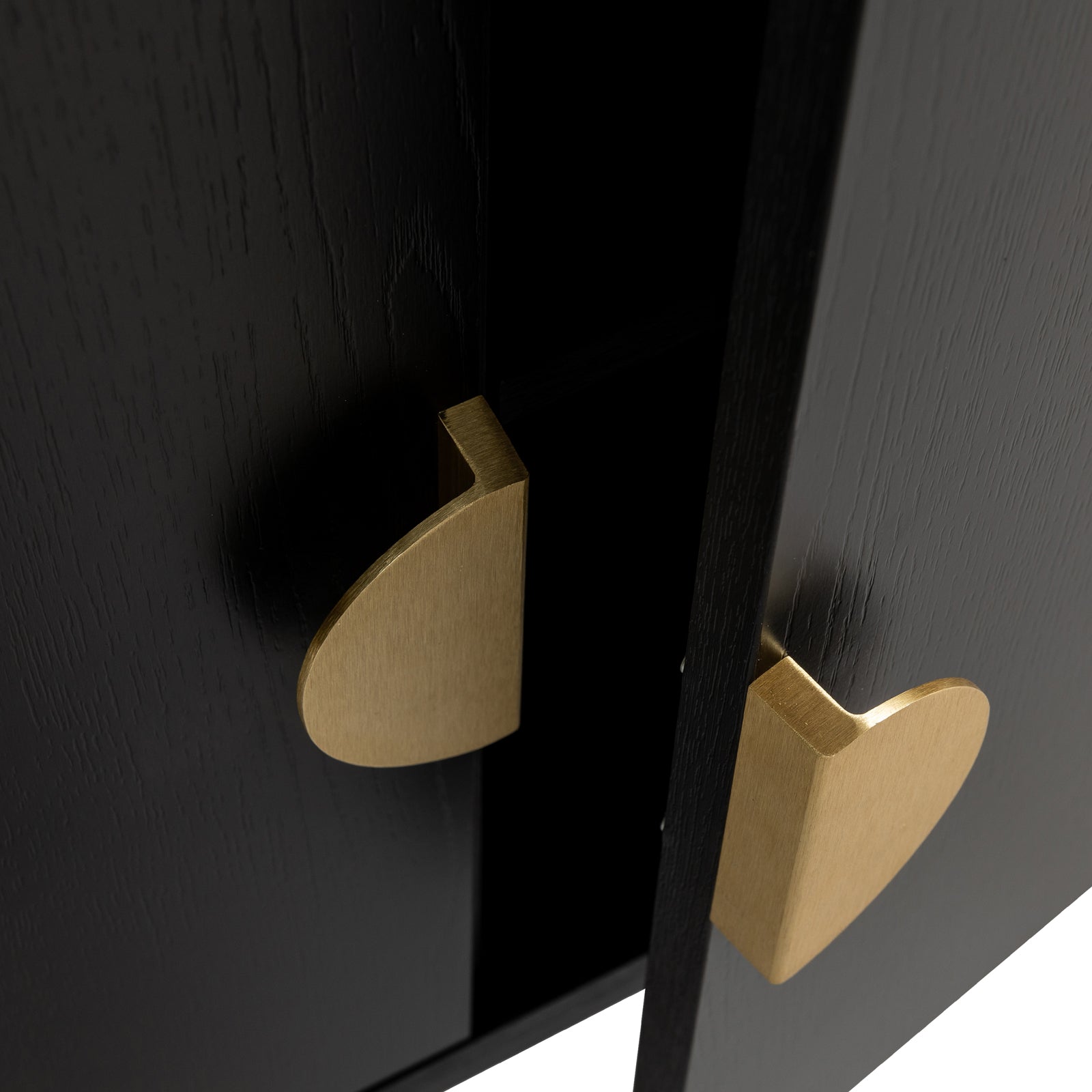 Erick 160cm 4-Door Storage Buffet Sideboard in Black features slightly ajar black wooden doors with teardrop-shaped brass pulls, revealing a dark interior, exuding modern elegance and functionality.