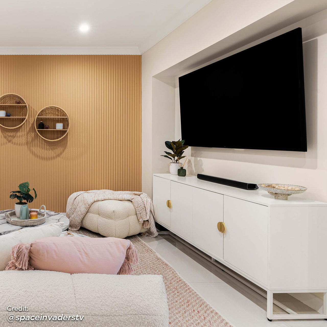 Erick 160cm 4-Door Storage Sideboard Buffet in White is showcased beneath a mounted TV, flanked by decor on a nearby console, embodying sleek minimalist design in a cozy, contemporary living room.