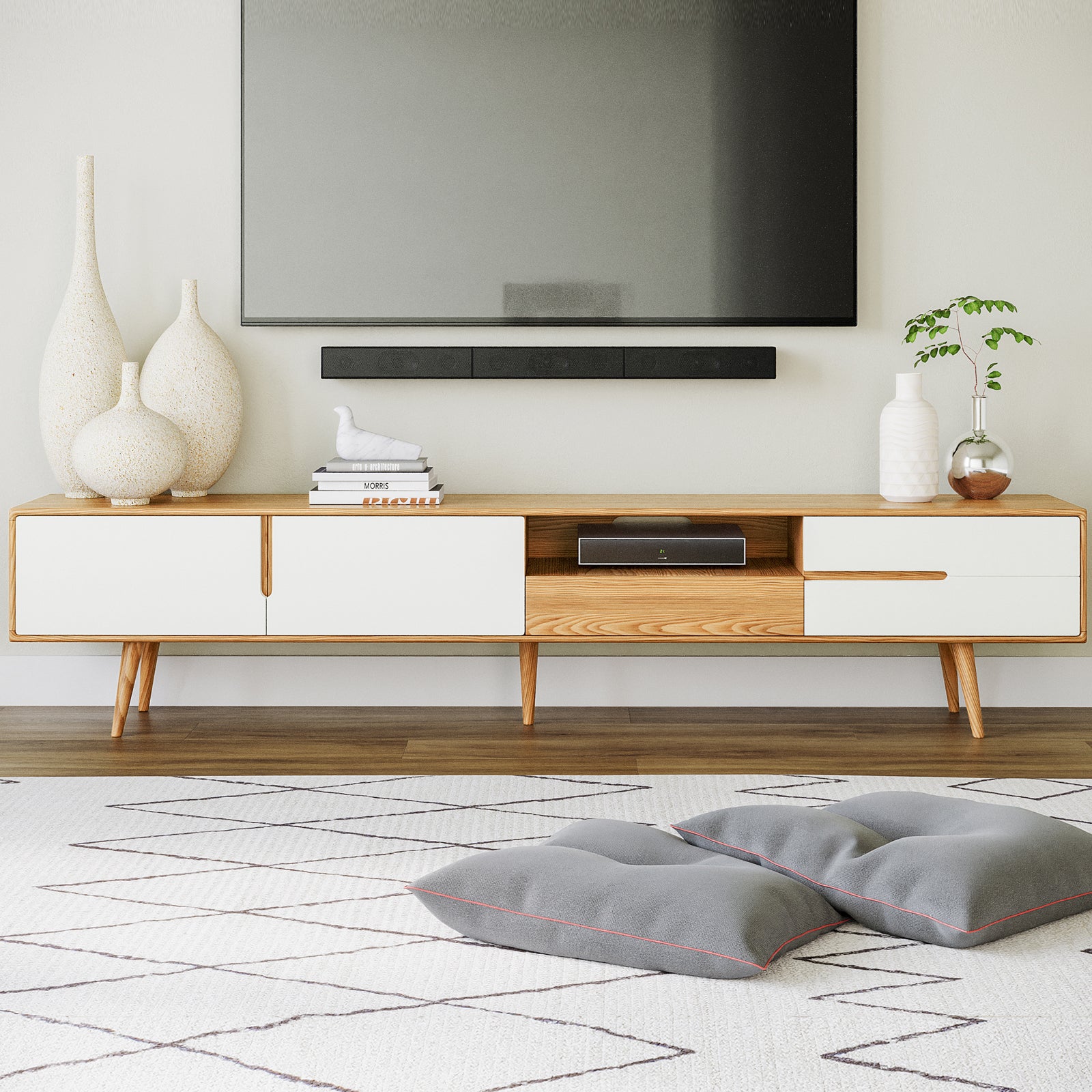 Estella 200cm American Oak Entertainment Unit in Natural with white-fronted drawers, topped with ceramic vases, books, and a bird figurine. Underneath, a cubby holds a cable box. Scandinavian style.