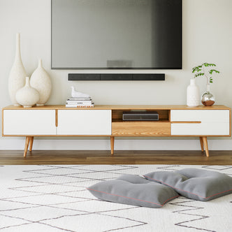 Estella 200cm American Oak Entertainment Unit in Natural with white-fronted drawers, topped with ceramic vases, books, and a bird figurine. Underneath, a cubby holds a cable box. Scandinavian style.