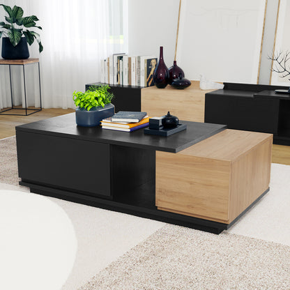 Freda 120cm Coffee Table with Storage in Black & Natural, featuring a sleek two-tone design, small blue planter, stacked books, and a black tray with sculptural objects on its surface.