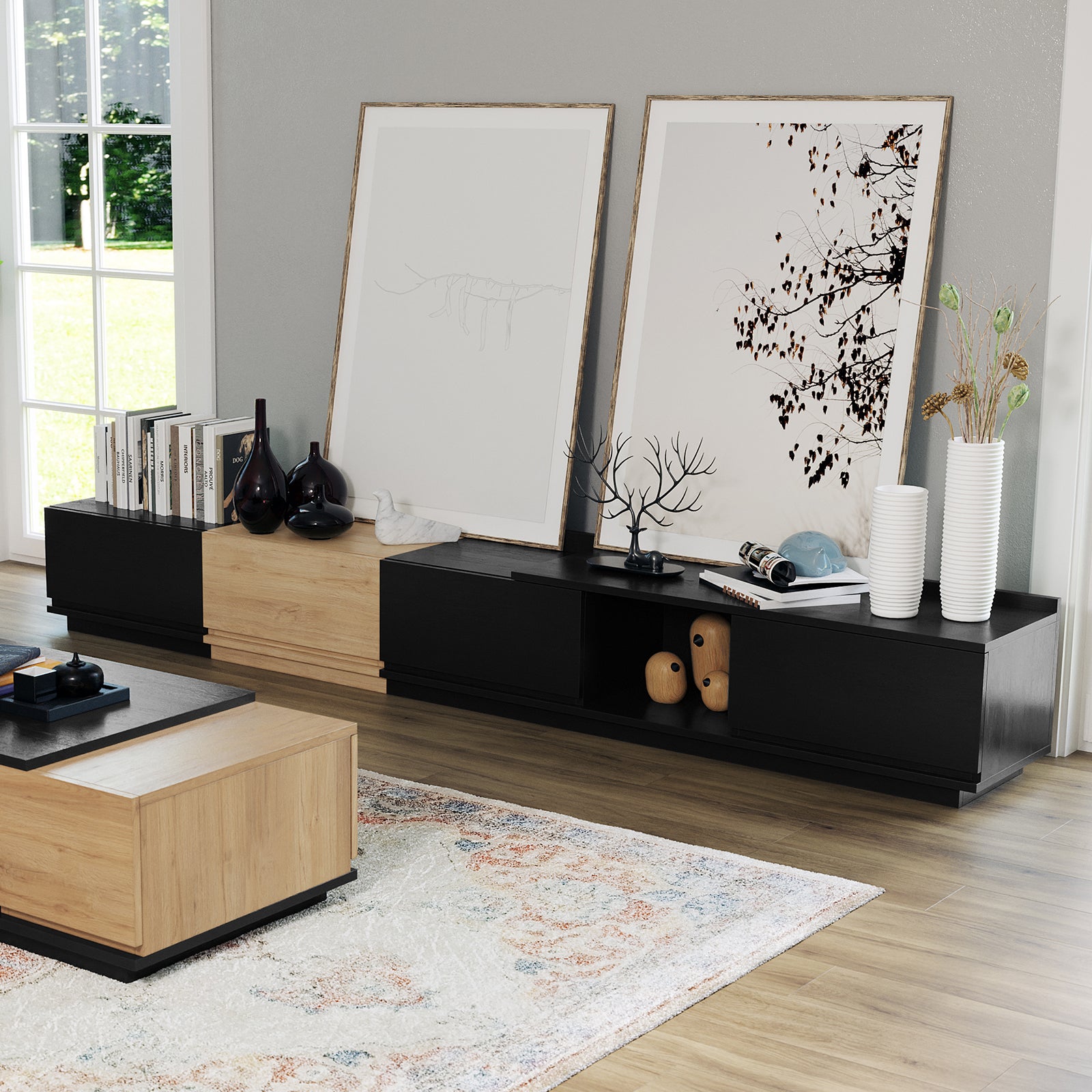Freda 280cm Modular Entertainment TV Unit in Black & Natural anchors a modern living room, adorned with art, vases, books, and a marble bird sculpture, reflecting sleek, minimalist design.