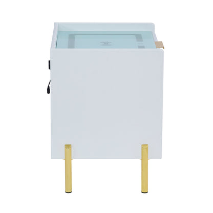 Gwen Smart Bedside Table with Wireless Charger in White features a modern design with a white cabinet and gold legs, a tinted glass top with Qi charging symbol, and a side power socket.