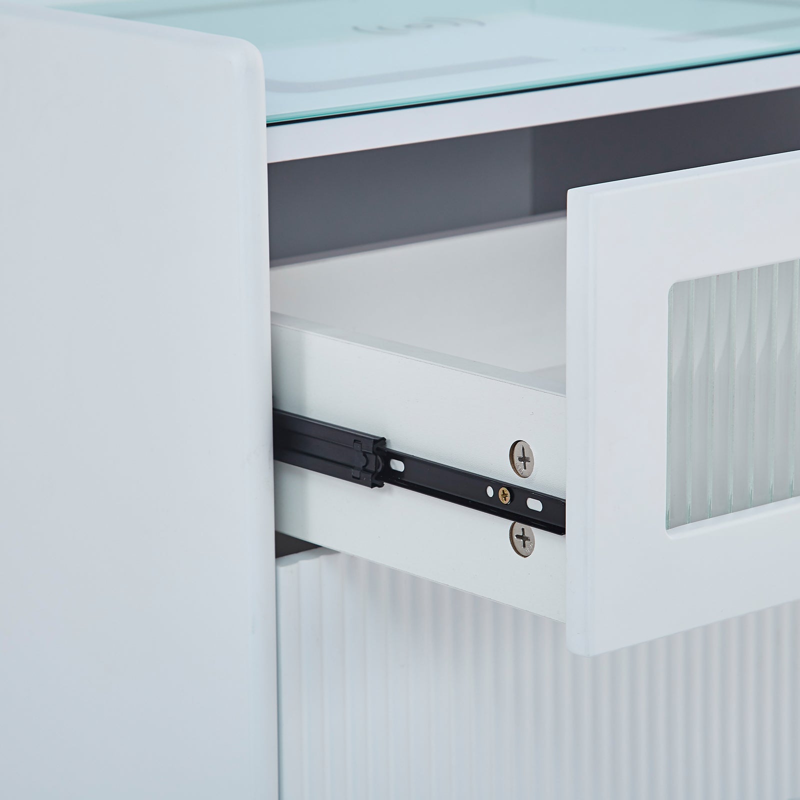 Close-up of the Gwen Smart Bedside Table with Wireless Charger in White, showcasing a partially open drawer with ribbed glass inset and visible black metal side-mount slide hardware.