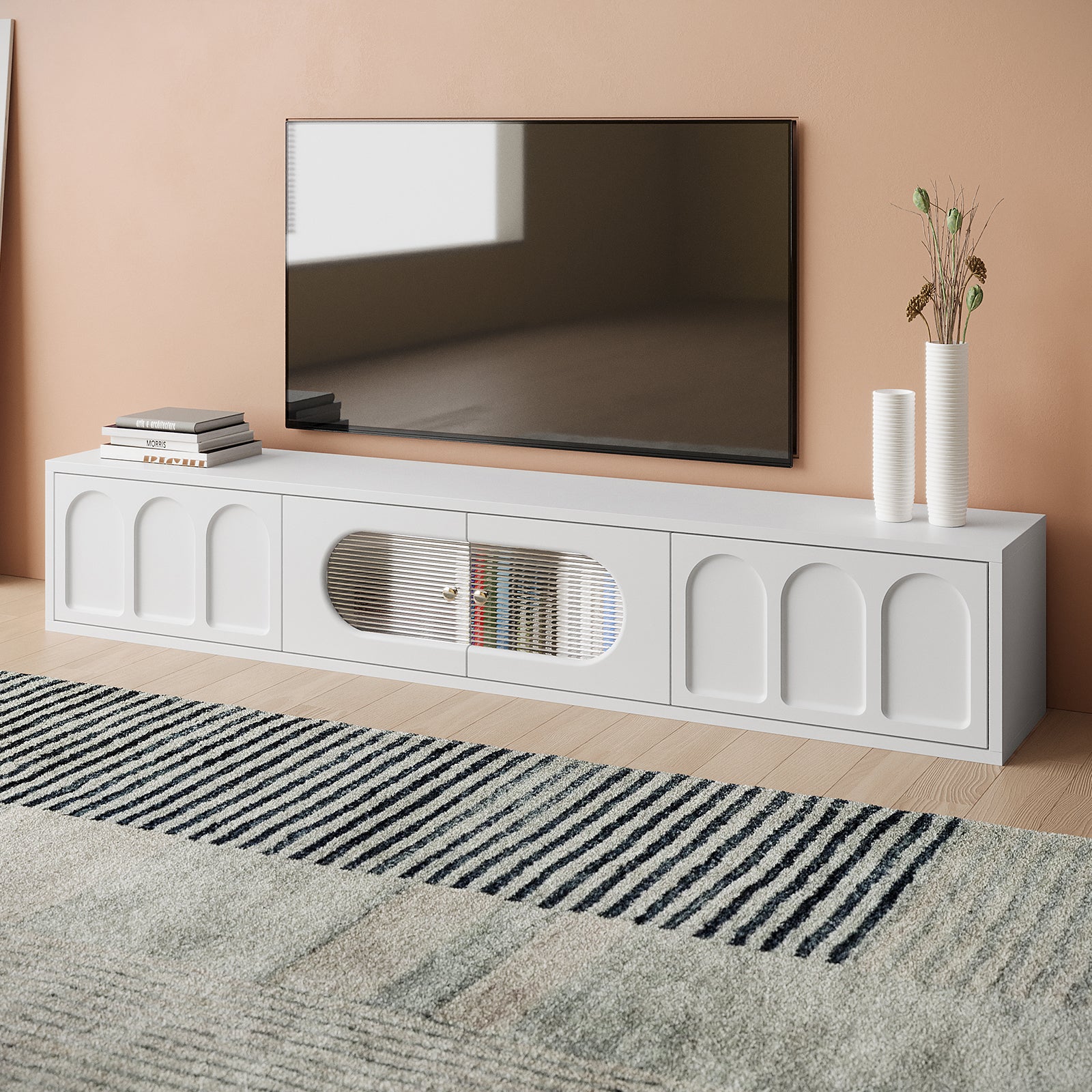 Hava 180cm Arched Entertainment Unit White, featuring sleek, arched drawer designs, fluted glass doors, and ample top space, set stylishly against a modern interior with stacks of books and cups.
