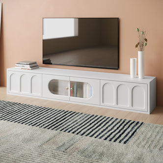 Hava 180cm Arched Entertainment Unit White, featuring sleek, arched drawer designs, fluted glass doors, and ample top space, set stylishly against a modern interior with stacks of books and cups.