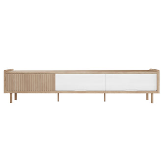 Hayden 200cm Fluted TV Entertainment Unit in Natural features a light oak frame, slender legs, sliding slatted door on the left, and two white-front sliding drawers on the right.