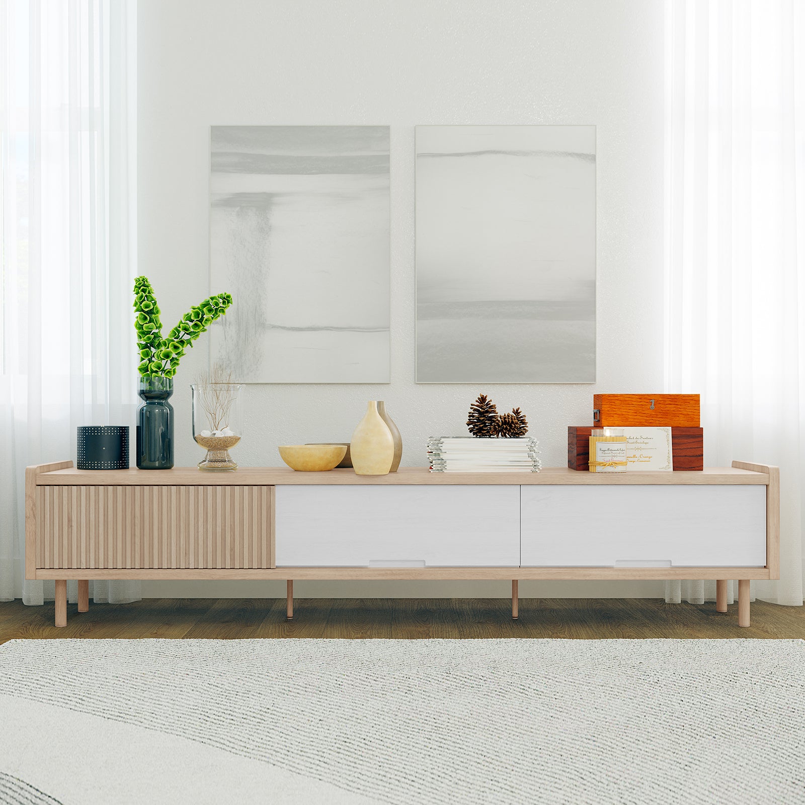 Hayden 200cm Fluted TV Entertainment Unit in Natural displayed with decorative items: a dark metal cylinder, blue vase, glass vessel, wooden bowls, magazines, and a keepsake box, creating a minimalist, chic living-room setup.