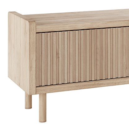 Hayden 200cm Fluted TV Entertainment Unit in Natural showcases a slatted front panel, solid wood top, and two round wooden legs, offering a stylish storage solution for your living room.