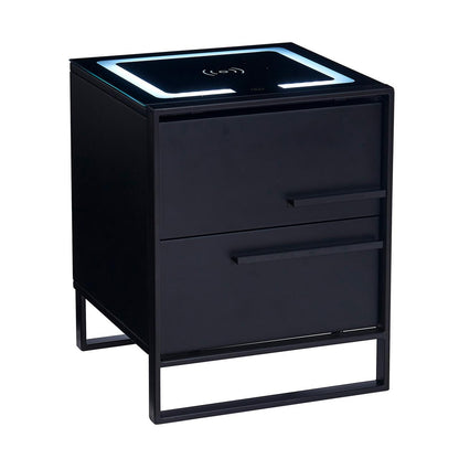 Isha Smart Bedside Table with Wireless Charger in Black, features a matte black cube design with two drawers, a sleek metal frame, and an integrated Qi wireless charging pad with LED light strip.