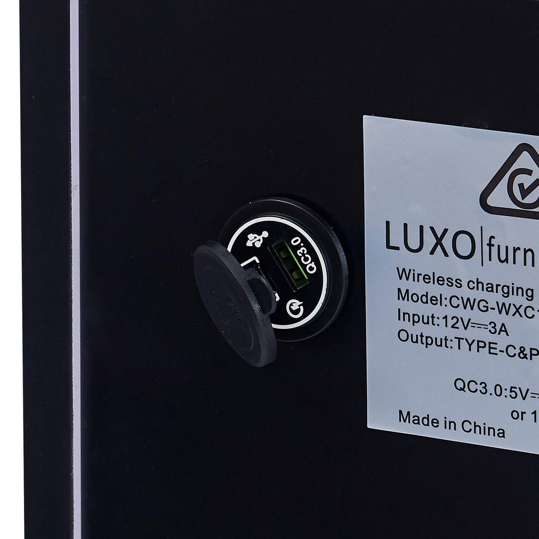 Isha Smart Bedside Table with Wireless Charger in Black features a built-in charging module, showcasing a round USB QC3.0 port and a wireless charging sticker, exemplifying modern convenience.