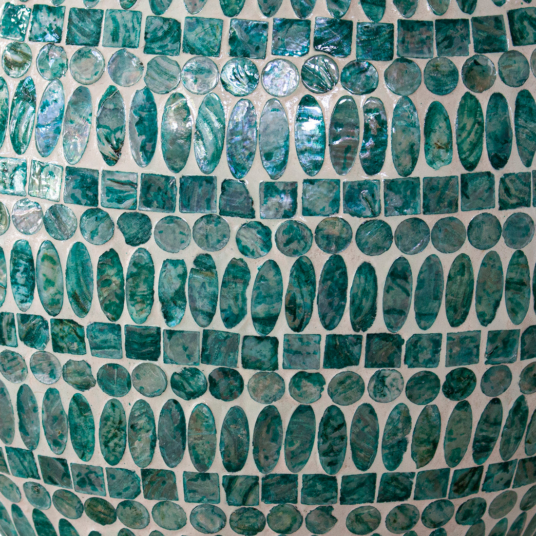 Laila 36cm Mother of Pearl Inlay Vase - Jade Green features a close-up of iridescent, oval, circular, and square green-blue mosaic tiles, elegantly inlaid on a vase's curved surface.