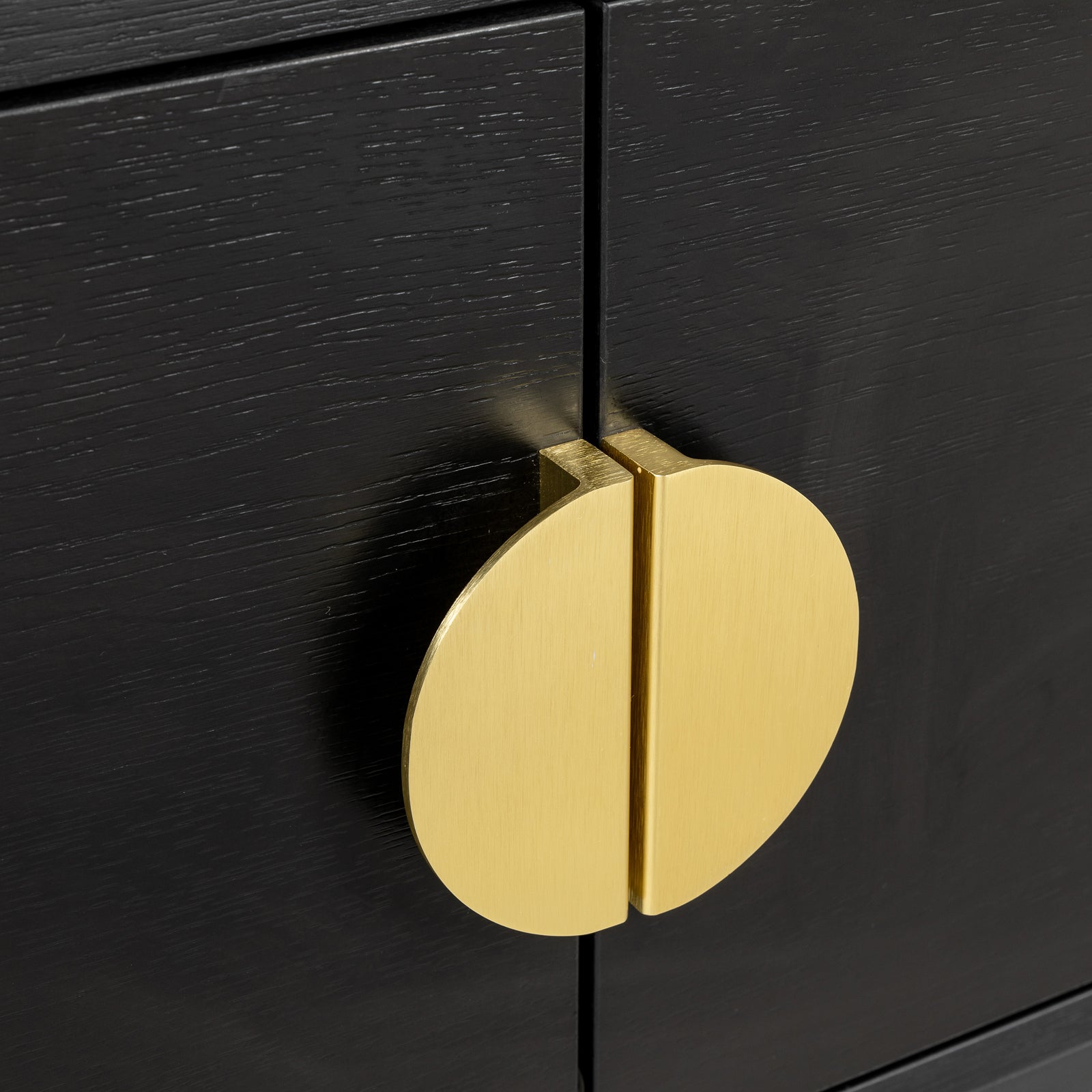 Close-up of Landon 160cm TV Entertainment Unit - Black, featuring black wood-grain cabinet doors and a circular brushed-gold metal pull, showcasing its modern and sleek design features.