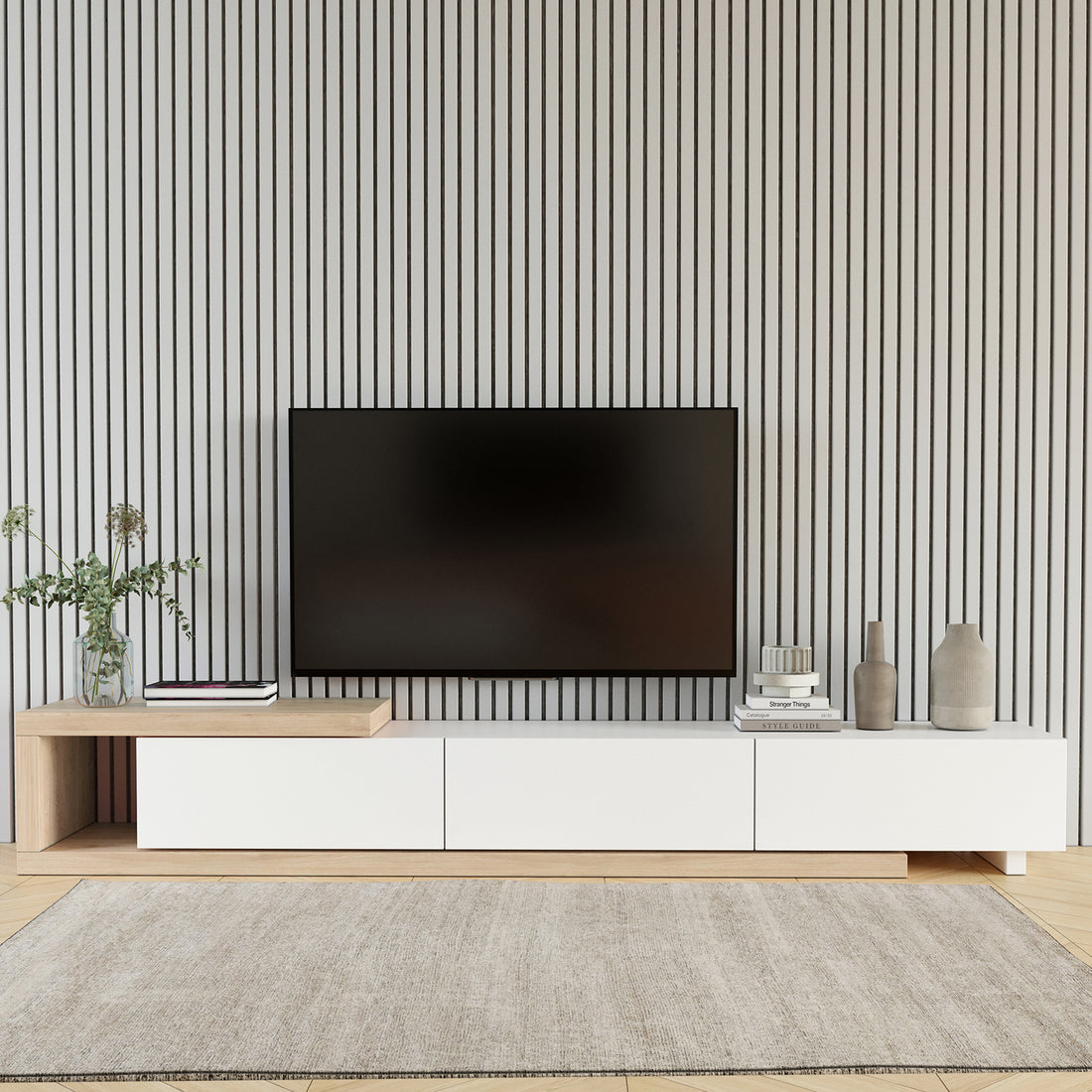 Mable Extendable Entertainment Unit with Drawers White, featuring a sleek two-tone design, natural wood and white finish, under a wall-mounted TV, with greenery, books, and decorative vases arranged neatly around it.