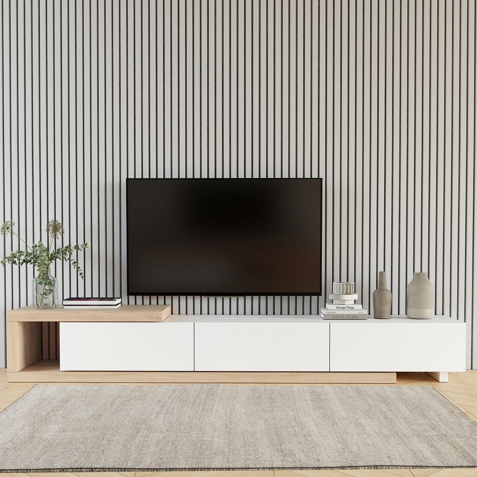 Mable Extendable Entertainment Unit with Drawers White, featuring a sleek two-tone design, natural wood and white finish, under a wall-mounted TV, with greenery, books, and decorative vases arranged neatly around it.