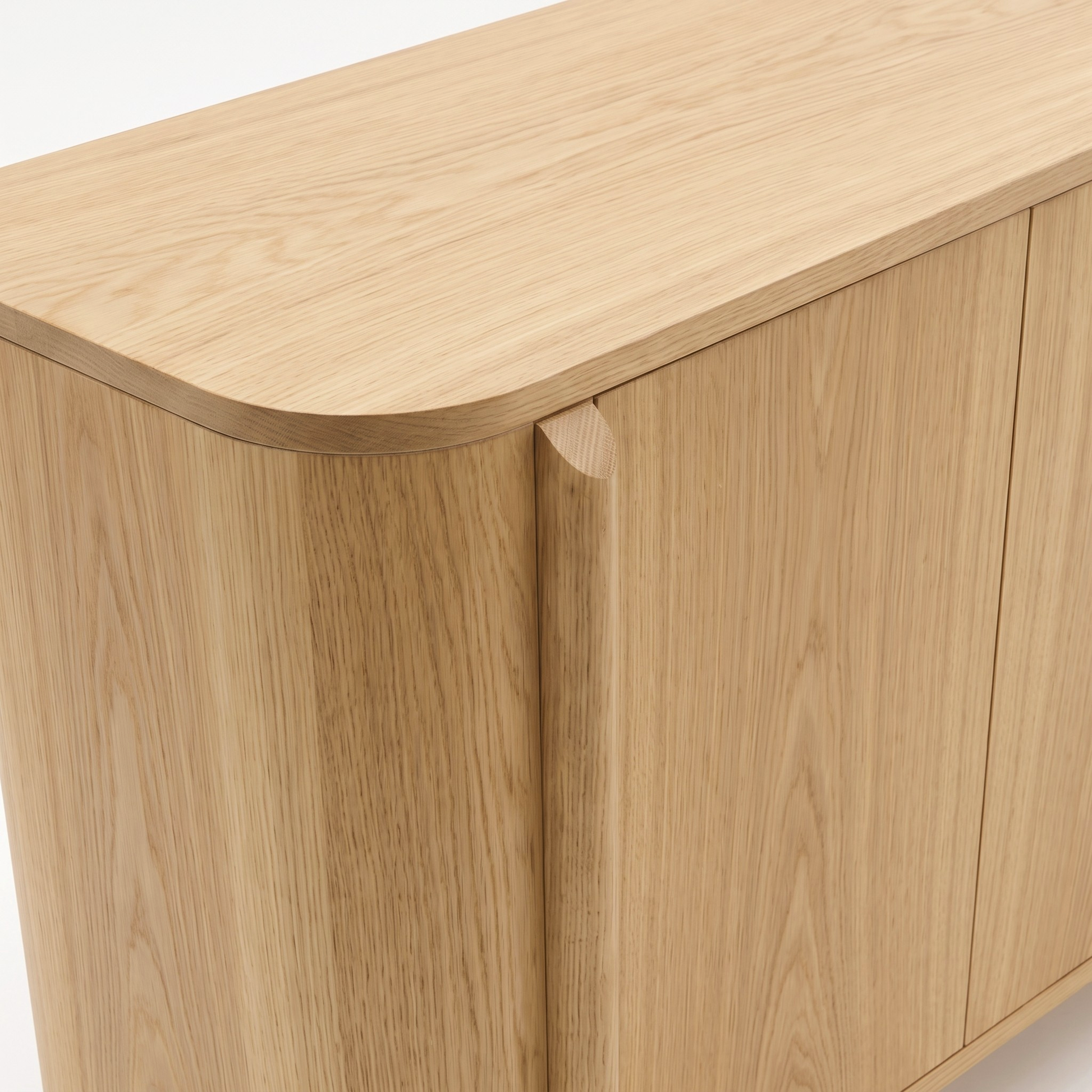 Partial view of a light wood cabinet on a white background
