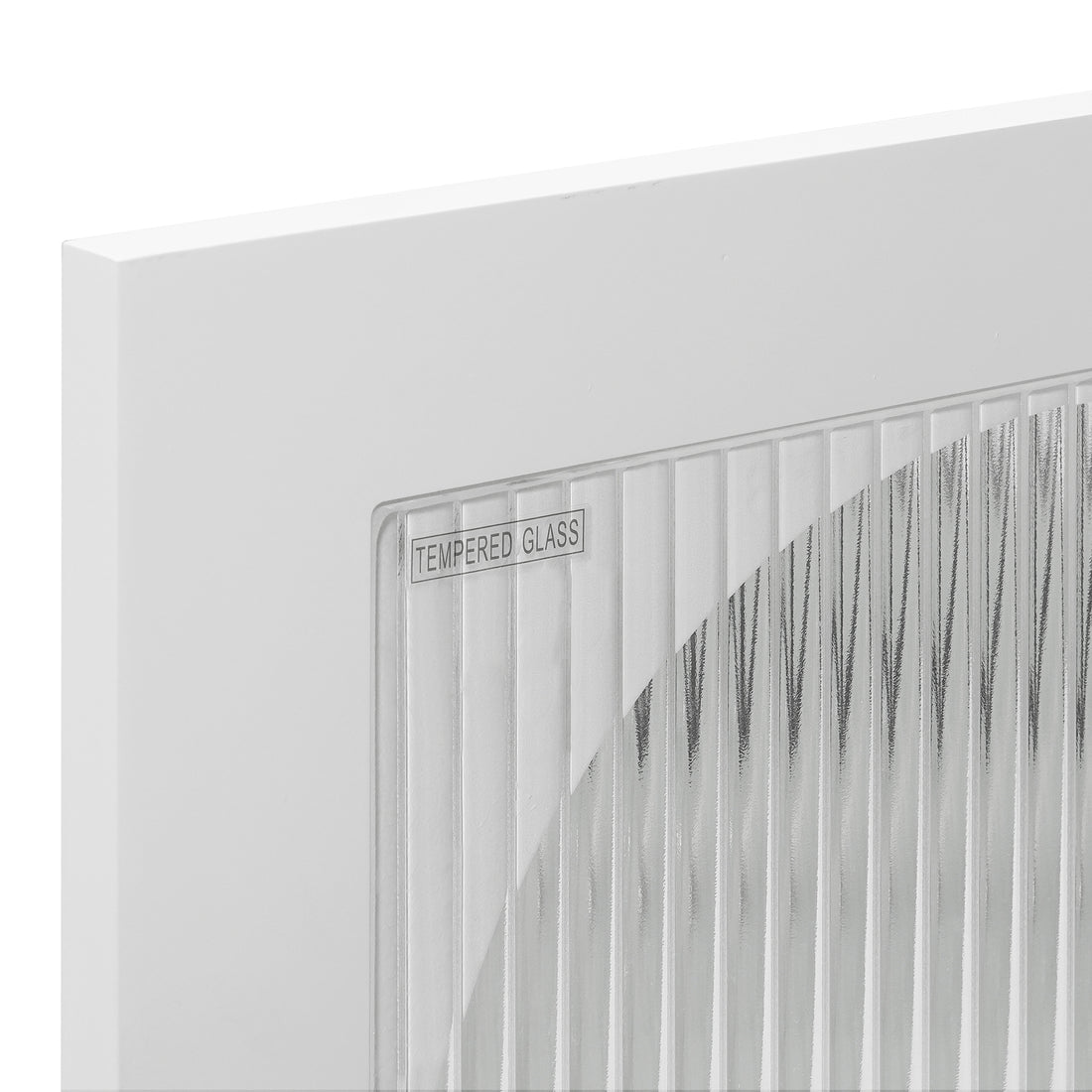 Close-up of the Matteau 46cm Bedside Table with Glass Door in White, showcasing its vertical-fluted tempered glass pane within a sleek white frame, labeled TEMPERED GLASS in the corner.