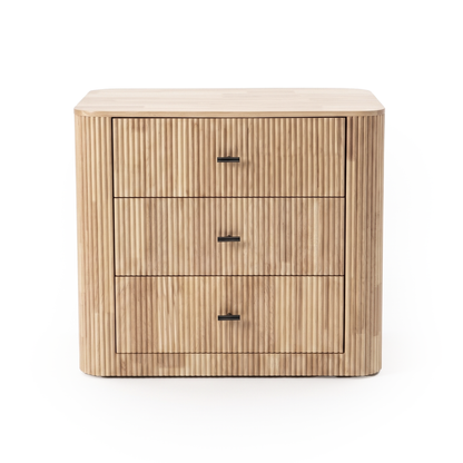 Three-drawer wooden chest with vertical fluted texture on a white background
