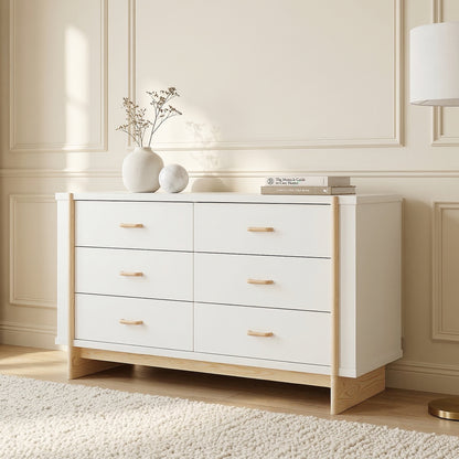 Six-drawer dresser in a styled room with wall paneling, decorative accessories, and sunlight