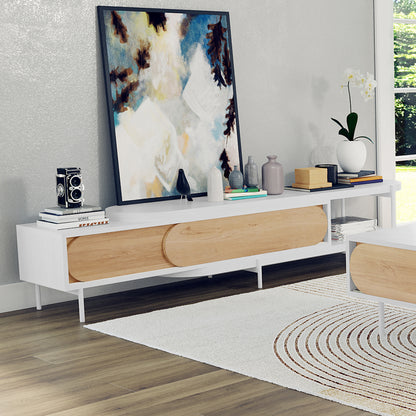 Novia 220-270cm Extendable Entertainment TV Unit in White features sliding oak-veneered doors, topped with books, a vintage camera, ceramic vases, and a white orchid, enhancing a modern living-room corner.