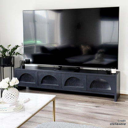 Philippe 200cm Arch Door TV Entertainment Unit in Black featuring fluted-glass cabinet doors on a sleek media console, paired with a modern living-room setup including a large TV and stylish decor.