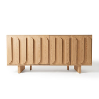 Light wood sideboard with sculptural vertically patterned front doors on a white background