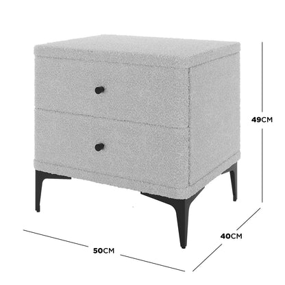 Shona Upholstered Boucle Bedside Table in Grey, featuring a soft boucle fabric with two drawers, set on slim black metal legs. Dimensions: 50 cm width, 40 cm depth, 49 cm height.