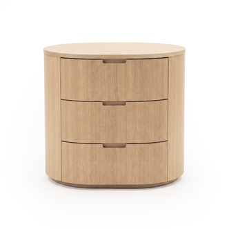 Three-drawer light wood rounded dresser photographed on a white background