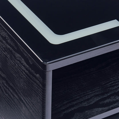 Close-up of Zayn Smart Bedside Table in Black, showcasing its glossy black top with light-colored trim, highlighting the modern design and functionality with integrated wireless charger.
