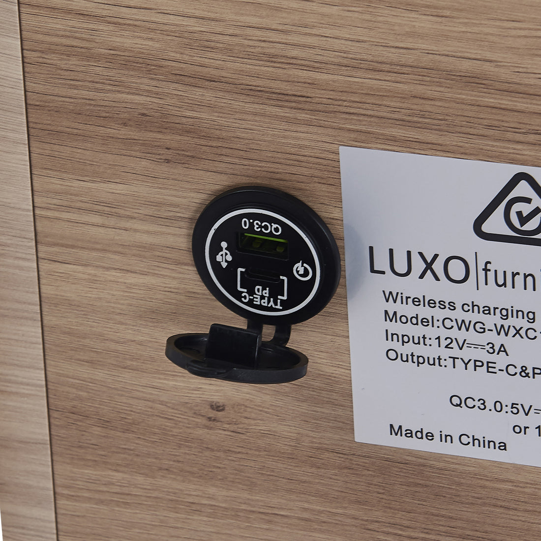 Close-up of the Zayn Smart Bedside Table with Wireless Charger, highlighting the sleek design with a Qi wireless charger on the tabletop and a black triangle with a check mark symbol.