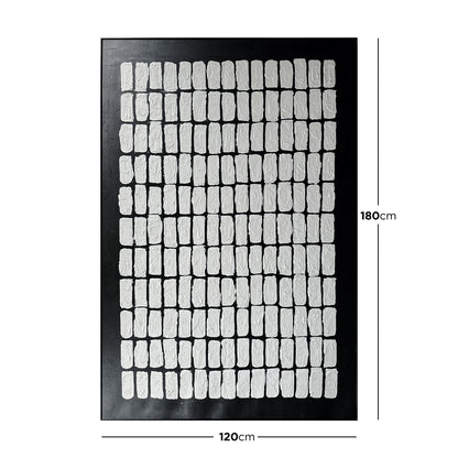 Elodie 100x150cm Framed Textured Canvas 3D Wall Art features a black panel with a grid of white, rectangular relief shapes, offering a minimalist, geometric design with hand-crafted texture.