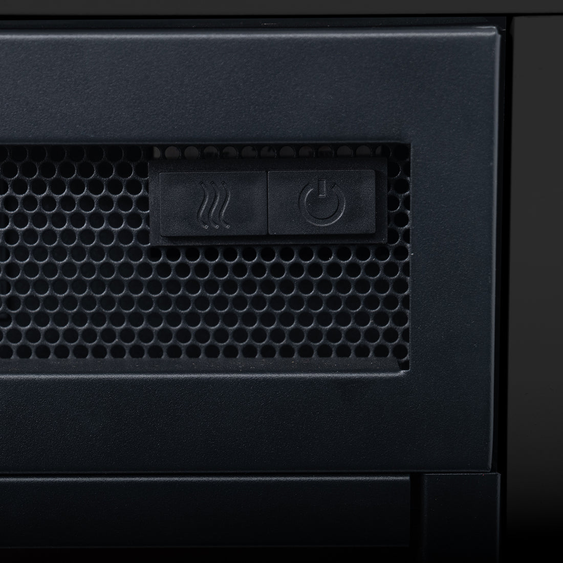Close-up of the Bago 129cm 1950W LED Electric Fireplace with Mantel Black, showing a perforated metal grille and two buttons for heat and power control, emphasizing its sleek, modern design.