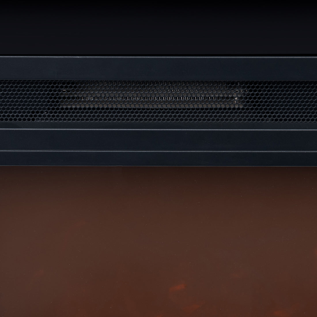 Bago 129cm 1950W LED Electric Fireplace with Mantel Black features a black metal housing, honeycomb grille, and warm orange glow from the simulated ember bed, offering a cosy, realistic fireplace effect.