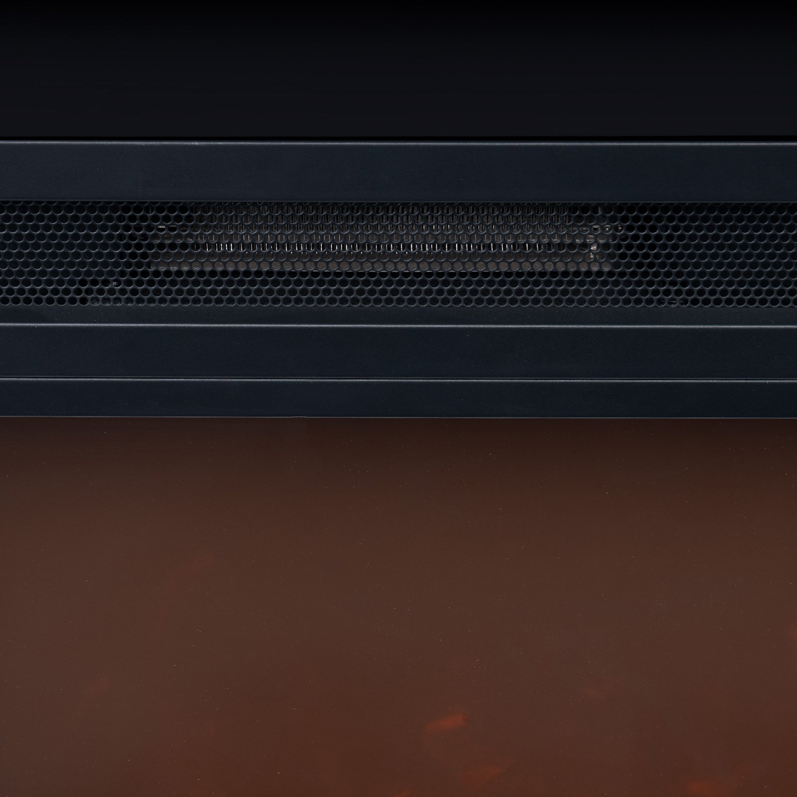 Bago 129cm 1950W LED Electric Fireplace with Mantel Black features a black metal housing, honeycomb grille, and warm orange glow from the simulated ember bed, offering a cosy, realistic fireplace effect.