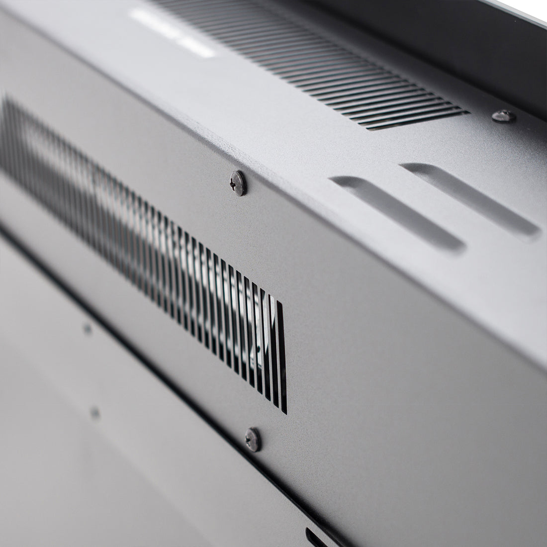 Dakota 60 Wall Mounted 1500W Electric Fireplace Heater features a sleek metal chassis with ventilation slots and mounting screws, showcasing modern design and functionality.