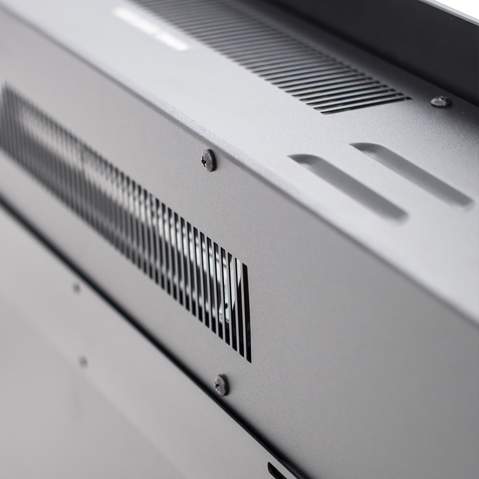 Dakota 60 Wall Mounted 1500W Electric Fireplace Heater features a sleek metal chassis with ventilation slots and mounting screws, showcasing modern design and functionality.