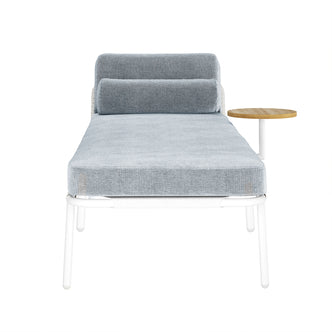 Andre Wicker Outdoor Sun Lounger Set of 2 in Light Grey features a modern white metal frame, light blue upholstered cushion, cylindrical bolster pillow, and an attached round wooden side table.