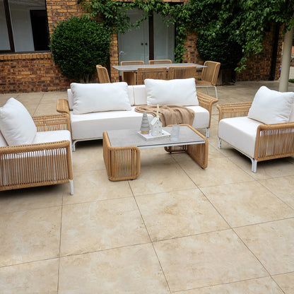 Avon 5-Seater Premium Aluminium Rattan Outdoor Lounge Set on a patio, showcasing its elegant design with plush cushions on a sturdy aluminum frame, complemented by a sleek ceramic tabletop.