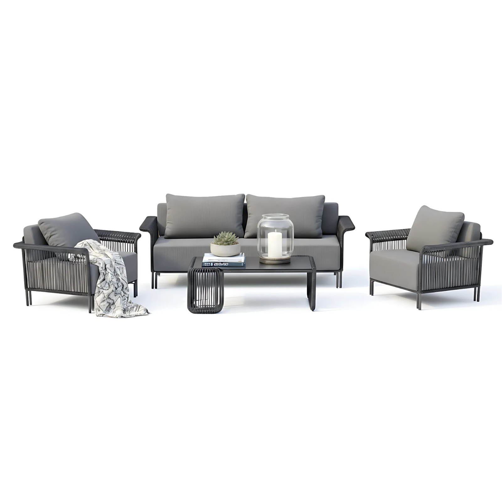 Avon 5 Seater Premium Rattan Outdoor Sofa Set in Grey features charcoal-gray cushioned armchairs, a matching sofa, and a sleek coffee table with books, a succulent, and a candle.