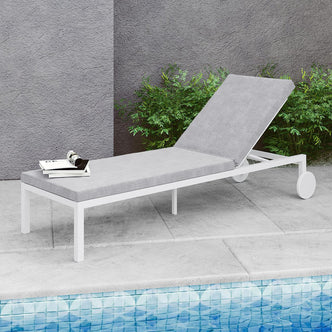 Bahiya Aluminium Outdoor Sunbed with Cushion displayed near a swimming pool, showcasing a sleek design on a sturdy frame, perfect for outdoor relaxation. A book rests on a nearby chair.