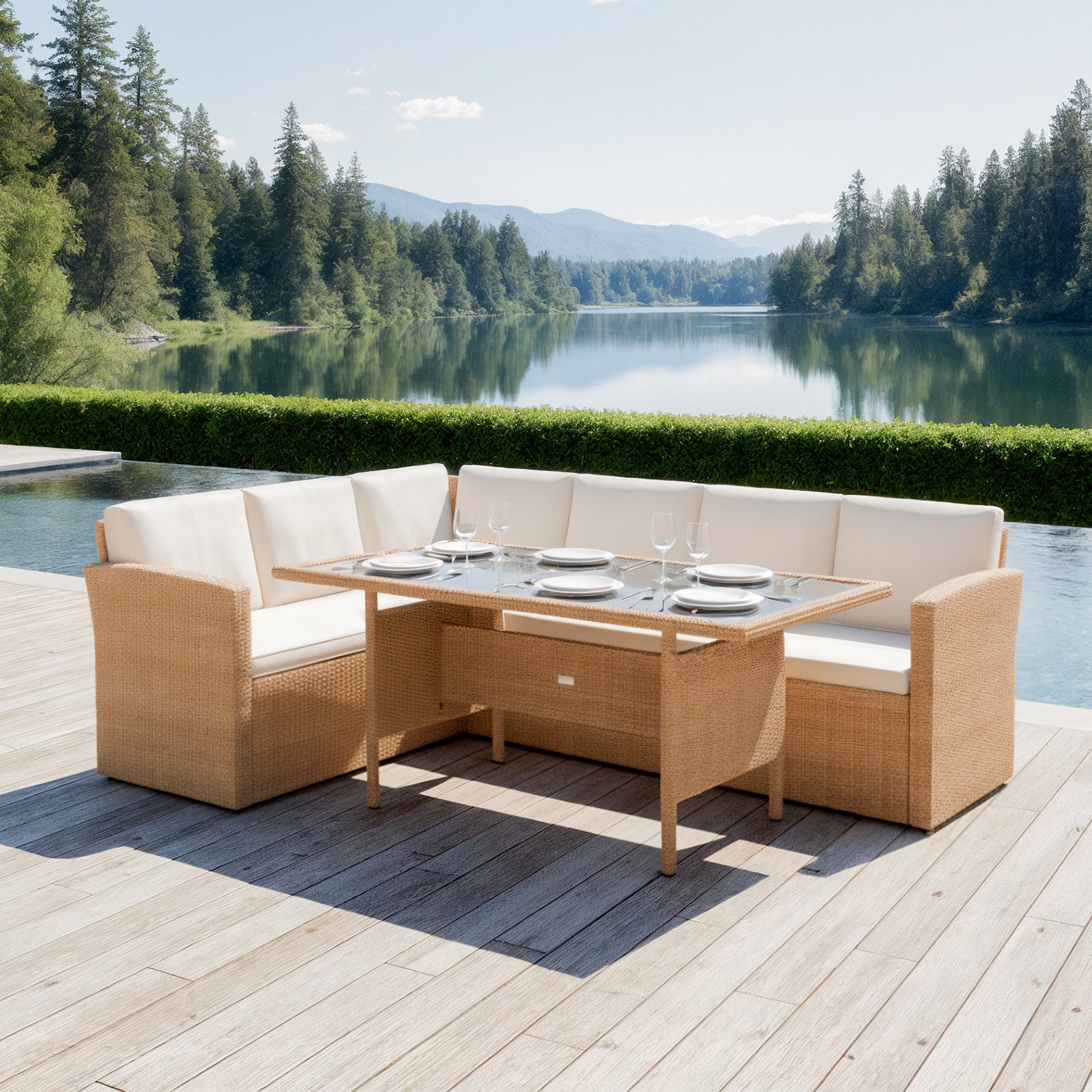 Ballena 6 Seater Wicker Outdoor Dining Set in Beige on a wood-plank deck, featuring an L-shaped wicker sofa with off-white cushions and a matching glass-topped table, overlooking a serene lake.