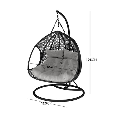 Basin 2-Seater Hanging Egg Chair with Cushion in Black features a freestanding design with a circular metal base, curved support arm, woven chair shell, and plush tufted cushion, perfect for indoor or patio lounging.
