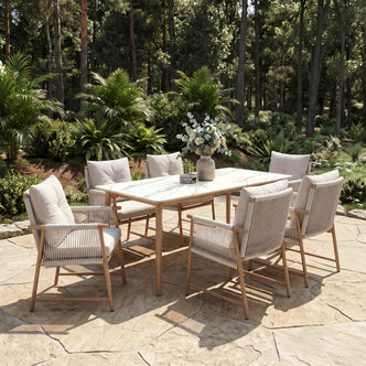 Dining table and six chairs arranged on an outdoor patio in a garden setting