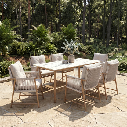 Dining table and six chairs arranged on an outdoor patio in a garden setting