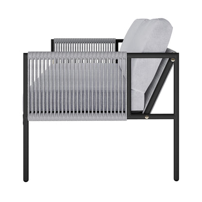 Side view of the Brujas 4 Seater Wicker Outdoor Lounge Set in Grey, featuring a sleek black metal frame, light-gray cushions, and gray rope-wrapped arm panels, embodying modern elegance and durability.