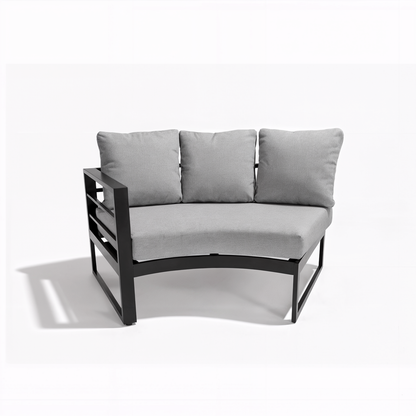 A single modular piece from the Callanna 5 Seater Curved Outdoor Lounge Set in Dark Grey, showcasing a curved seat and three grey back cushions on a sleek black metal frame.