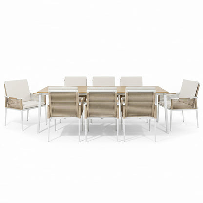 Casara 9 Piece Outdoor Dining Set in White and Beige features a light-wood table with white metal legs, six side chairs, and two armchairs with beige rope-woven backs and cushioned seats.